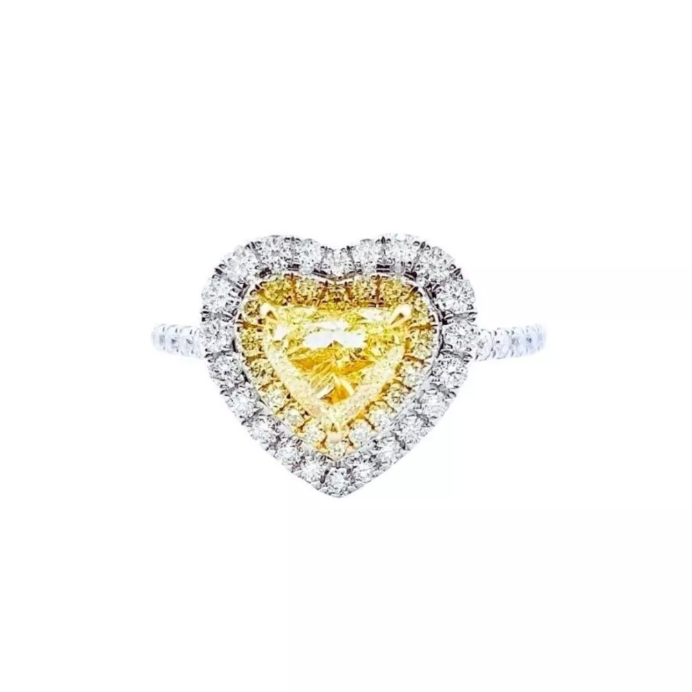 Anillo en oro blanco con diamante Fancy Yellow talla corazón y diamantes Fancy Yellow e incoloros talla brillante (1.201 ct total)