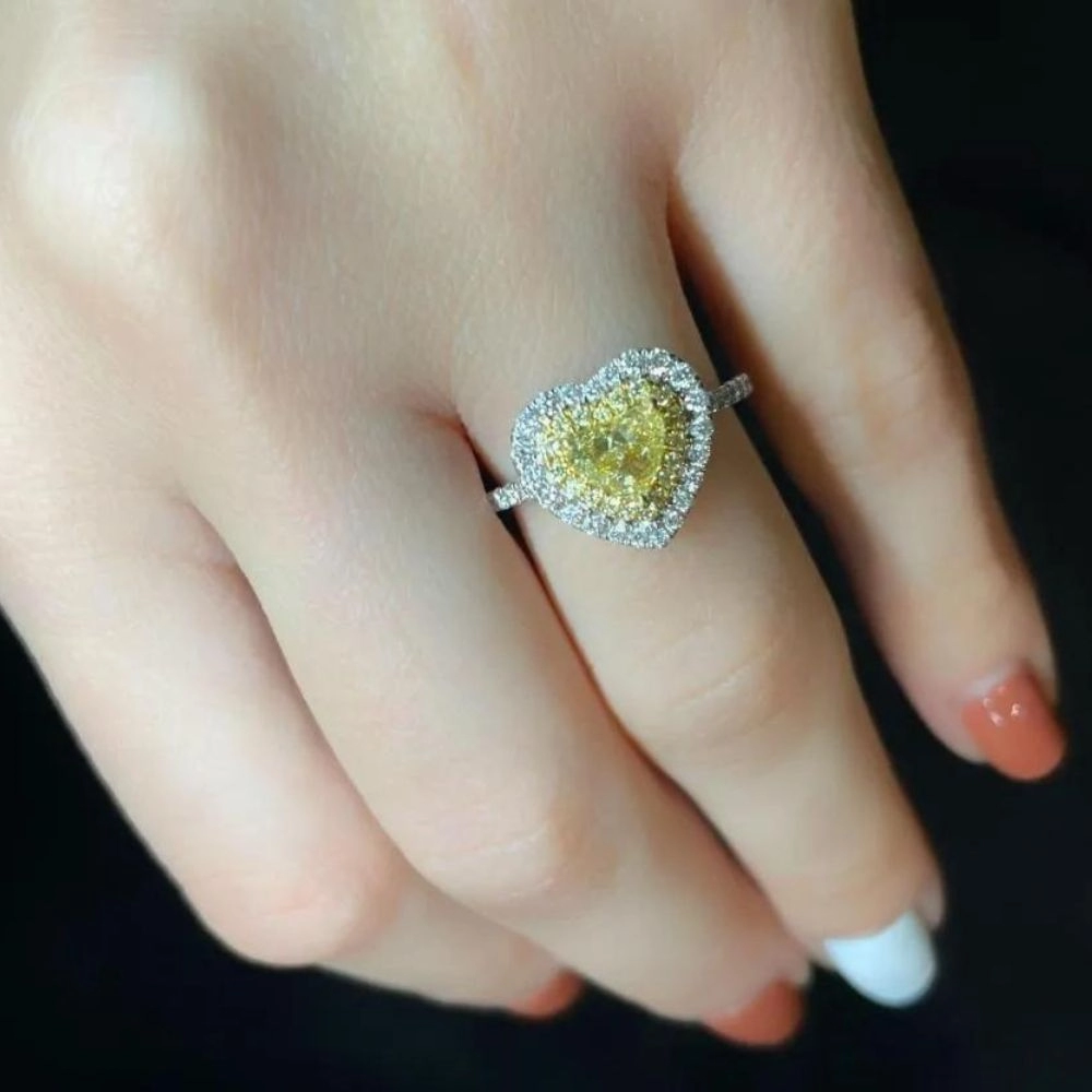 Anillo en oro blanco con diamante Fancy Yellow talla corazón y diamantes Fancy Yellow e incoloros talla brillante (1.201 ct total)